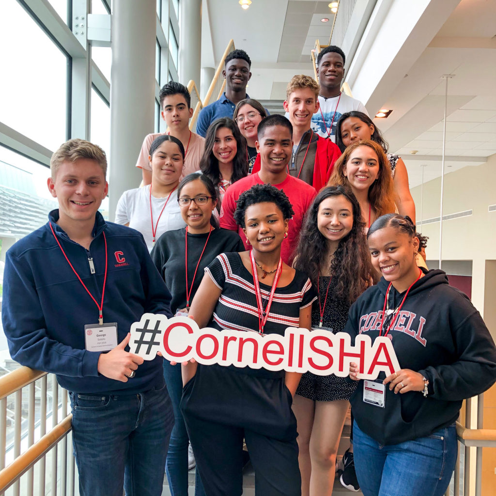 Students holding a #CornellSHA banner
