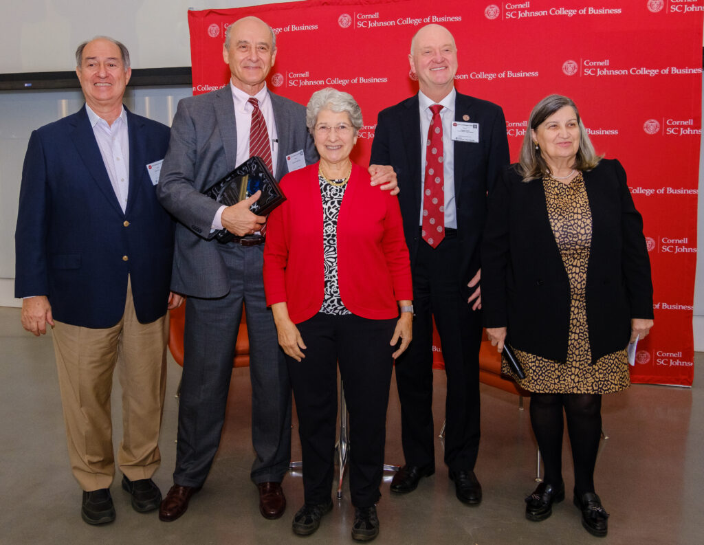 Standing for a picture in front Cornell banner: Roberto Cañizares, Eduardo Padilla, Gail Cañizares, Andrew Karolyi, Lourdes Casanova