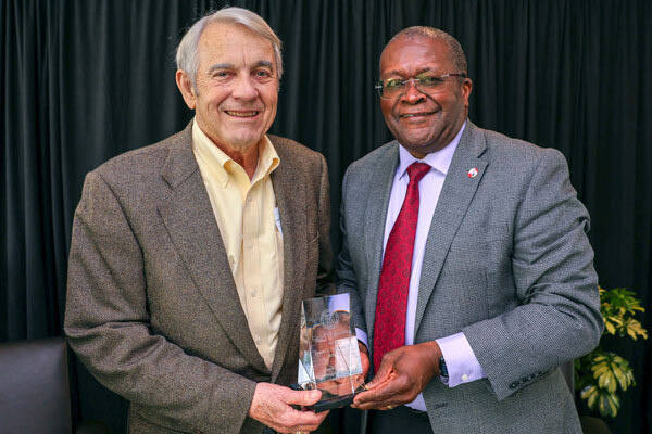 Image of Lynden Archer, right, the Joseph Silbert Dean of Engineering, presenting James C. Morgan ’60, MBA ’63 with the Cornell Engineering Distinguished Alumni Award.